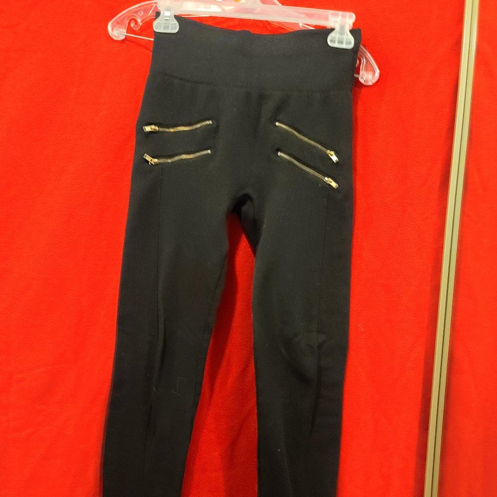 Black leggings with golden decorative zippers